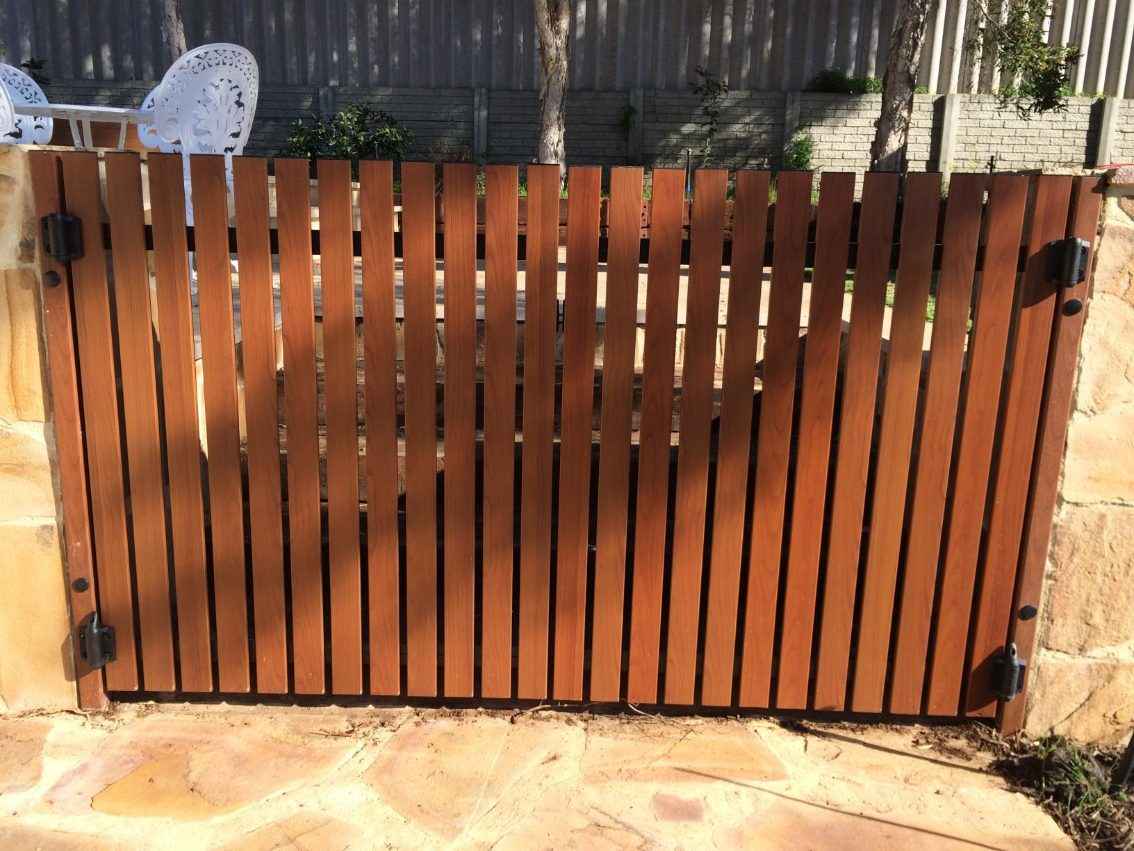 Wooden swimming pool gate installation.